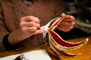 Woman creating a Venetian festival mask.